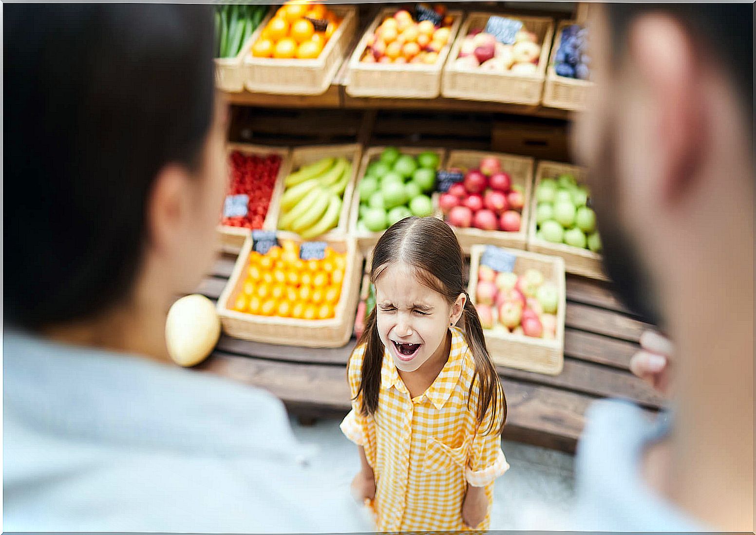 Little girl having a tantrum at the greengrocer.