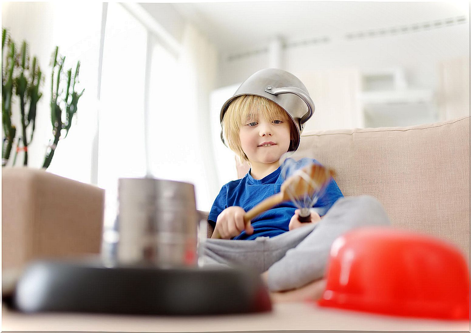 Child playing homemade music instruments.