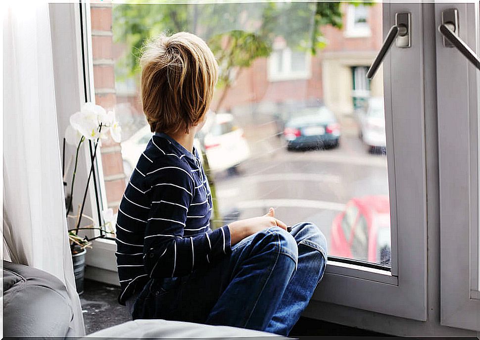 Child with absent autism looking out the window.