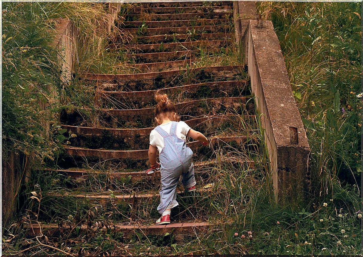 Girl climbing huge stairs to learn not to give up.