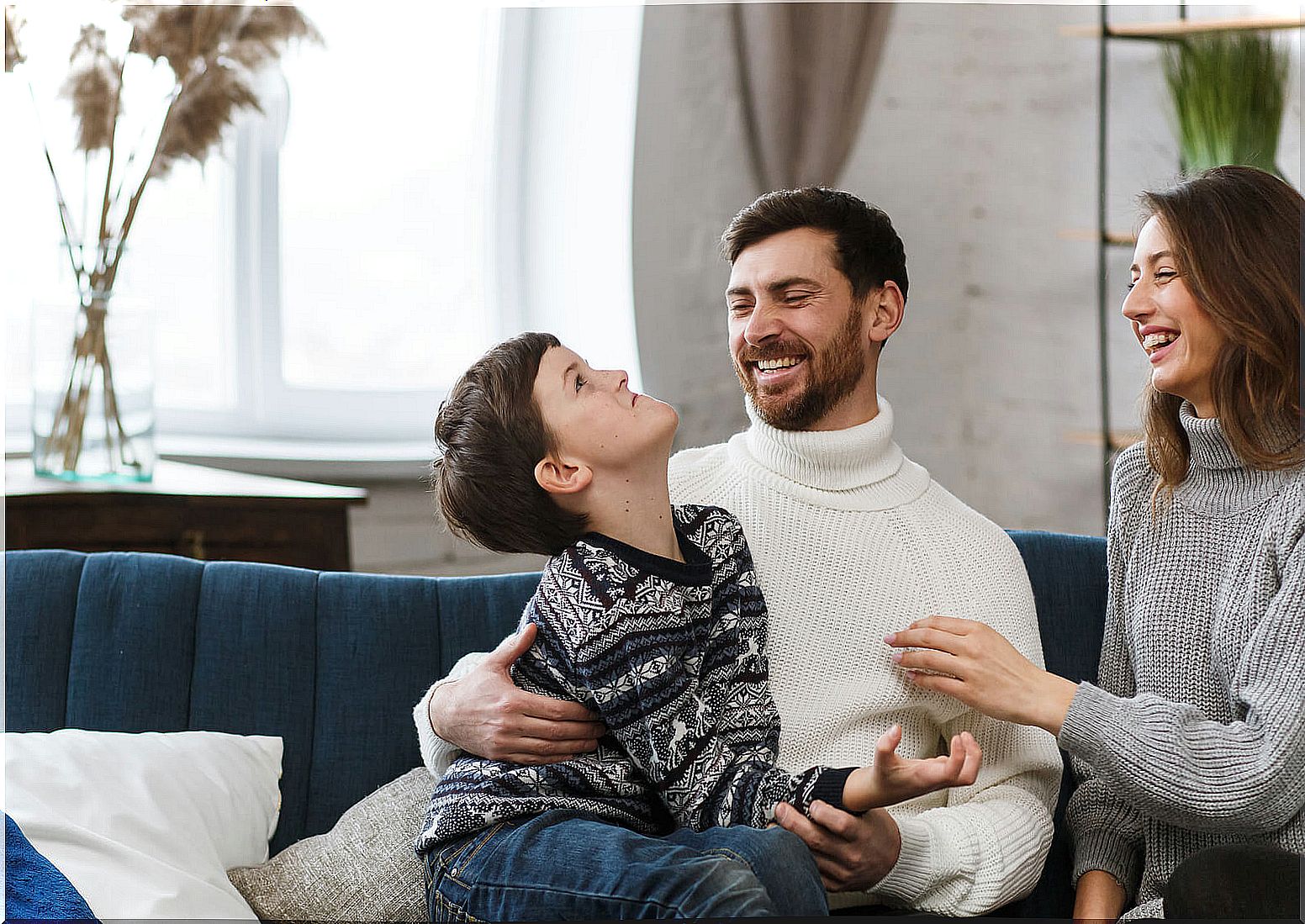 Parents playing with their child at home.