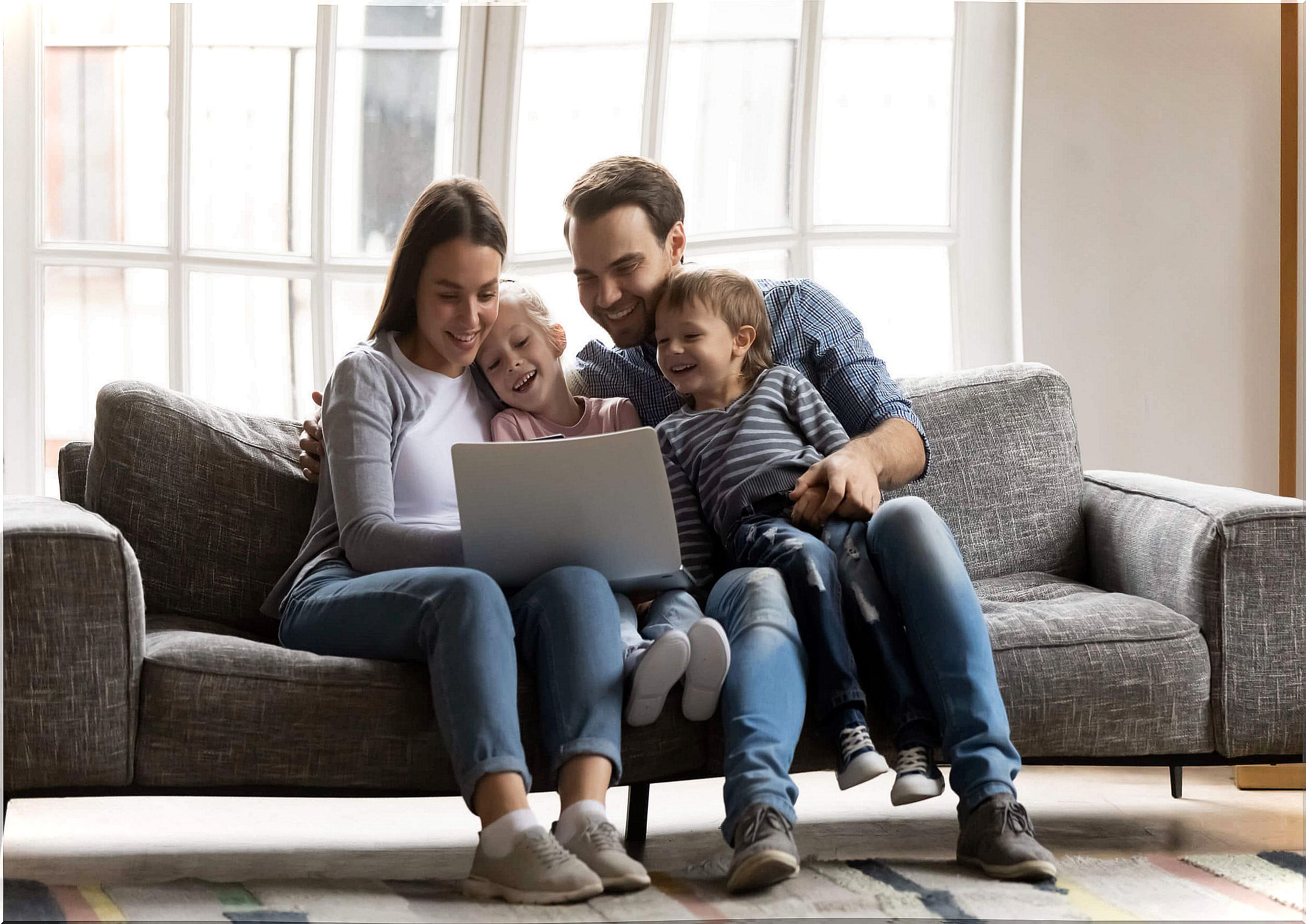 Family watching some of the best educational channels on the computer as part of the free online plans.