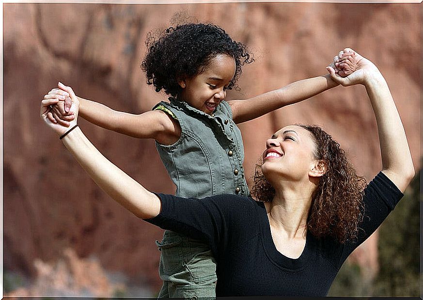 Very happy mother and daughter holding hands.