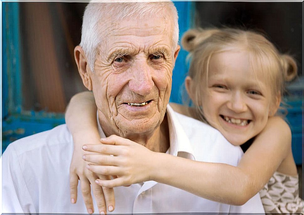 Granddaughter giving her grandfather a hug.