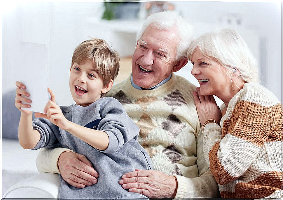 Grandson taking a selfie with his grandparents.