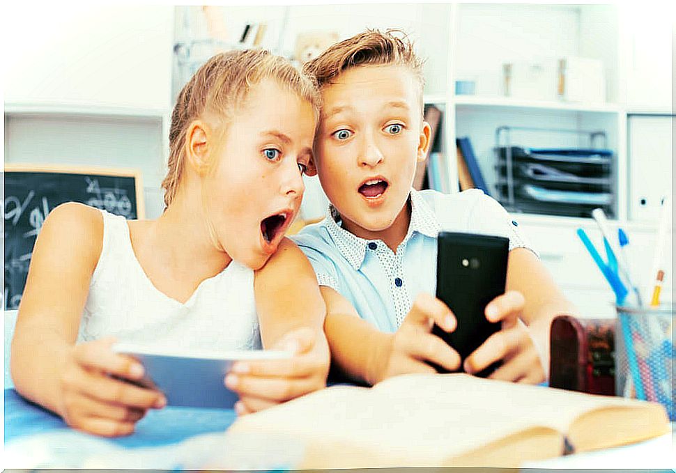 Teenagers watching videos on their mobile to the people they follow on bookstagram.