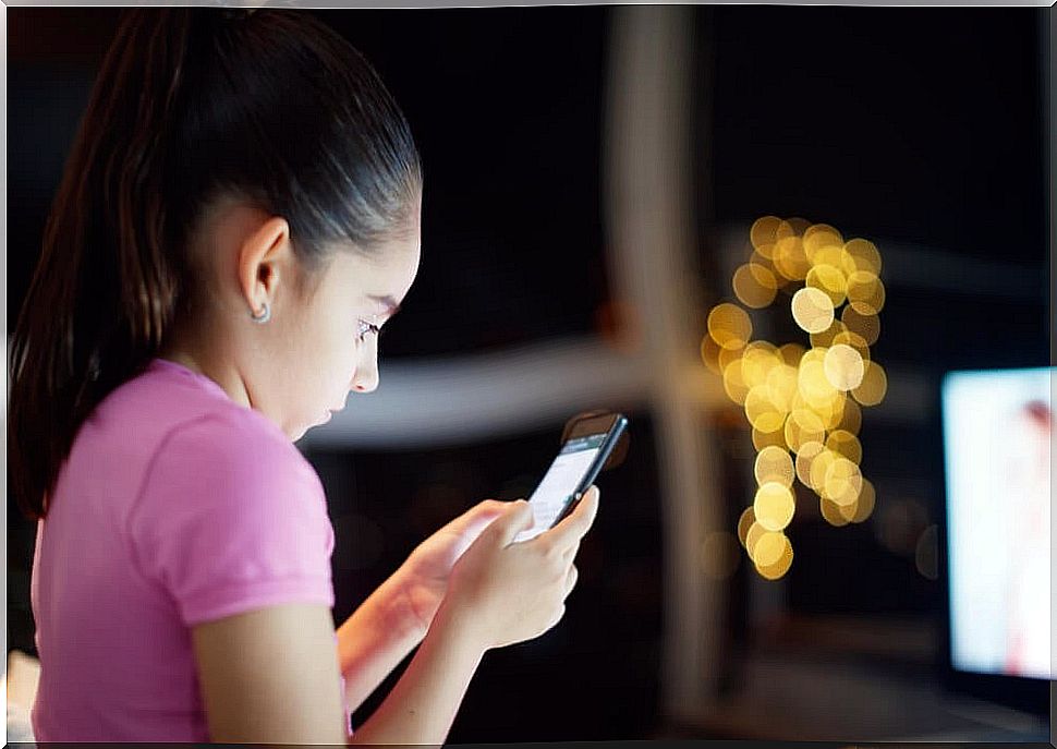 Girl using mobile with internet access to see bookstagram news.