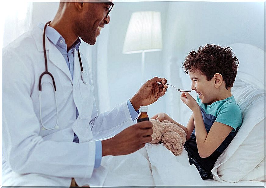 Doctor giving child paracetamol or ibuprofen.