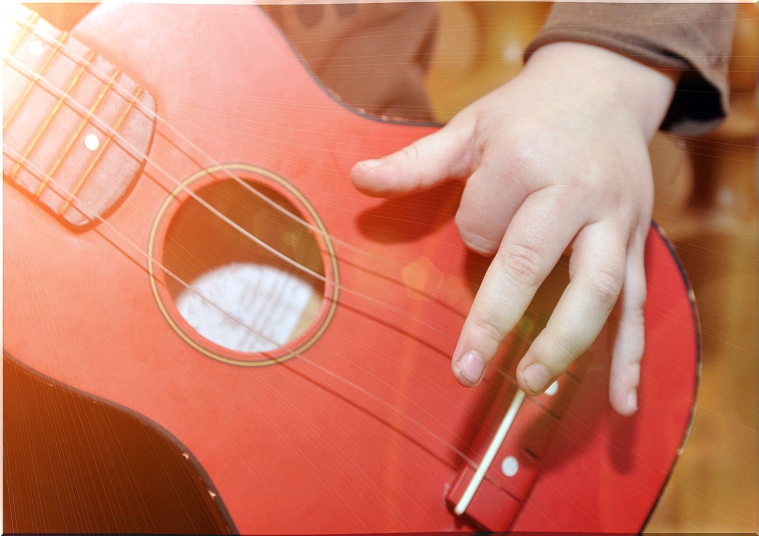 Boy playing a toy guitar.