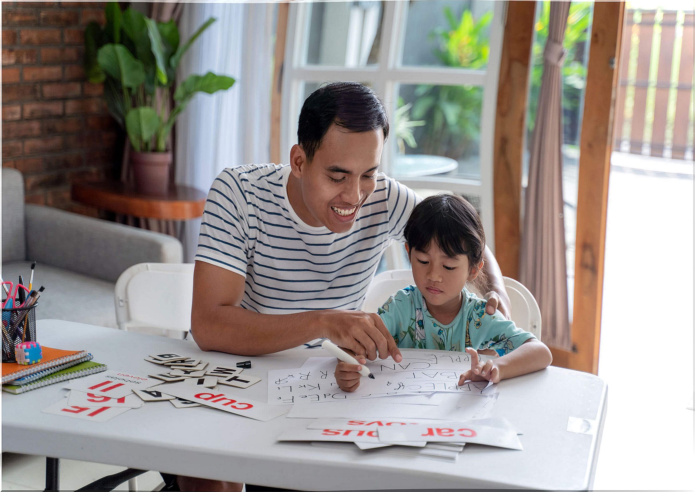 Father helping his daughter to study to give her a good education.