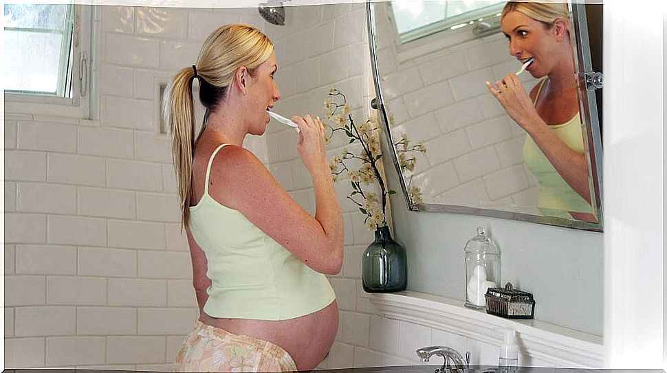 Pregnant woman brushing her teeth.