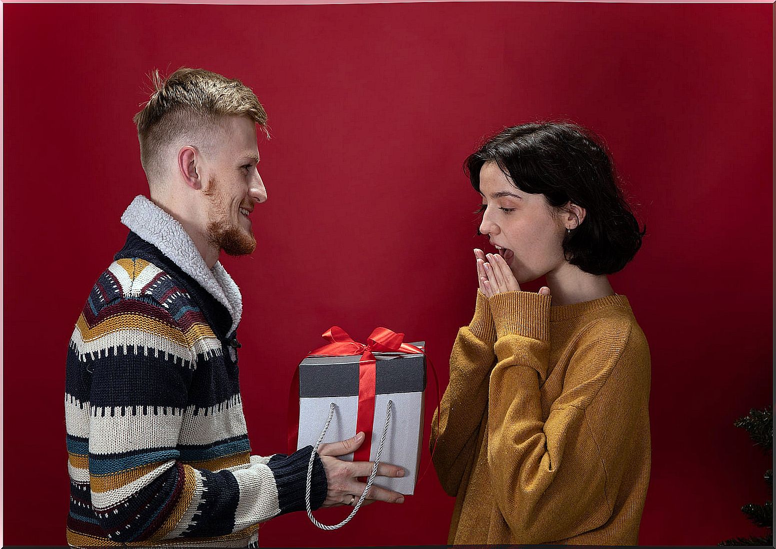 Couple giving each other surprise gifts.