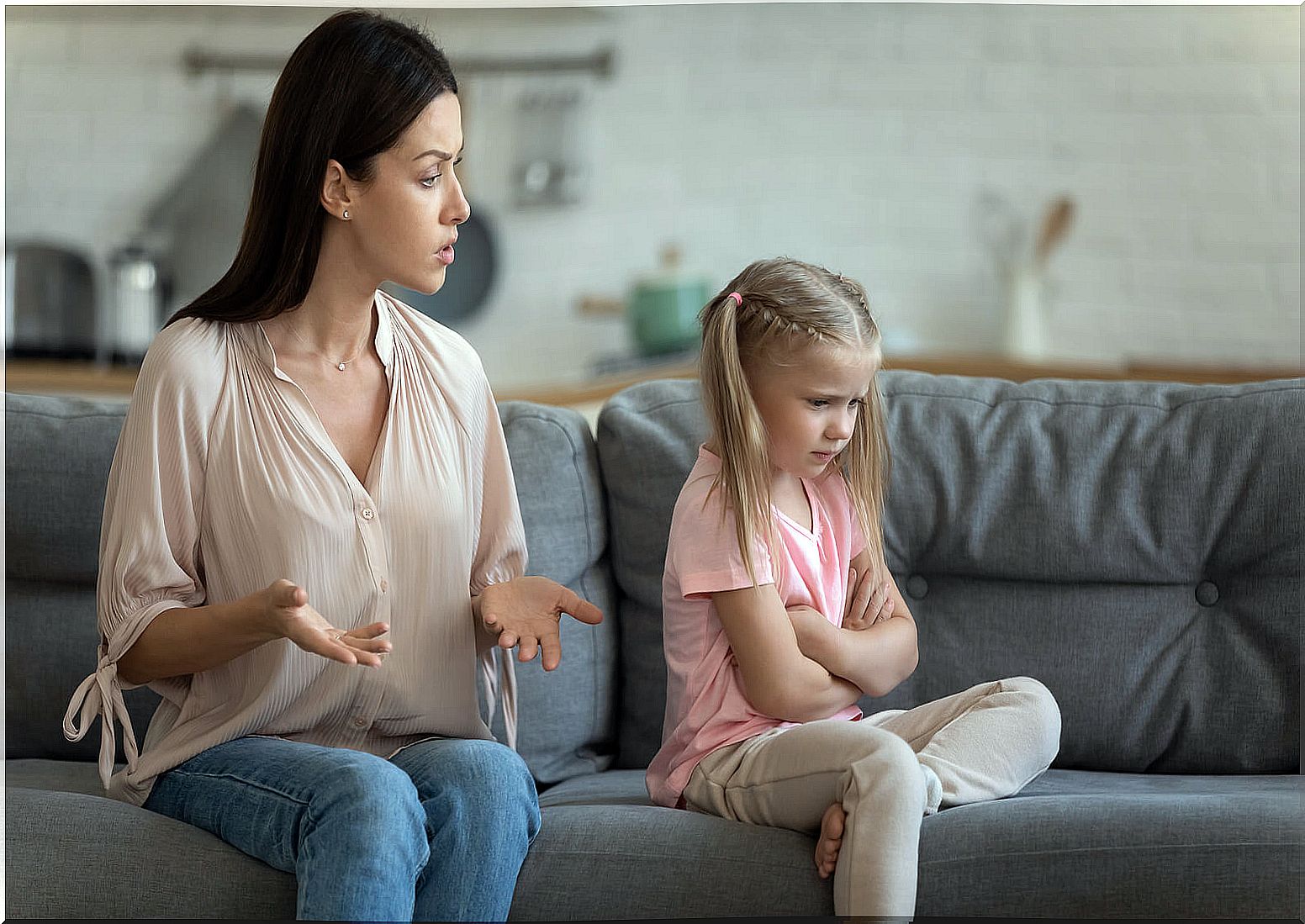 Mother scolding and educating her daughter after her bad behavior.