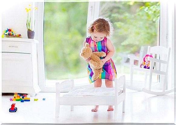 Little girl playing in her new bedroom