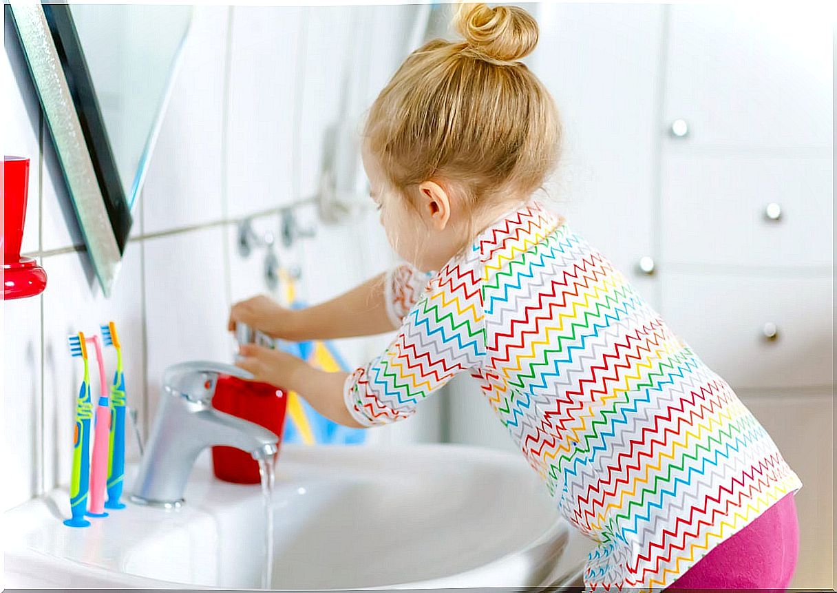 Girl washing her hands.