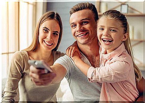 A family sharing in front of the TV with cartoons