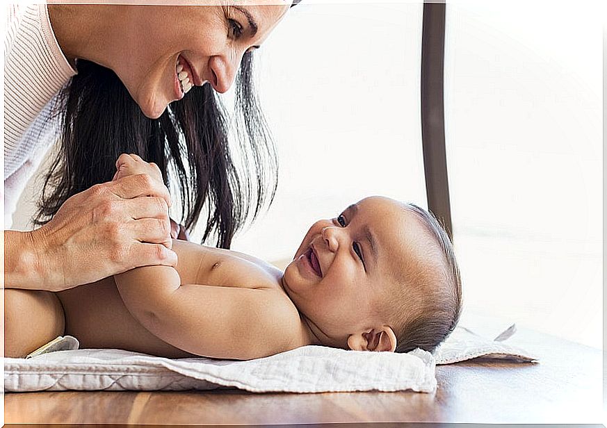 Mom encouraging non-verbal language with her baby.